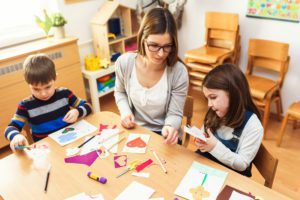 Preschool Teacher with Children at Kindergarten - Creative Art Class